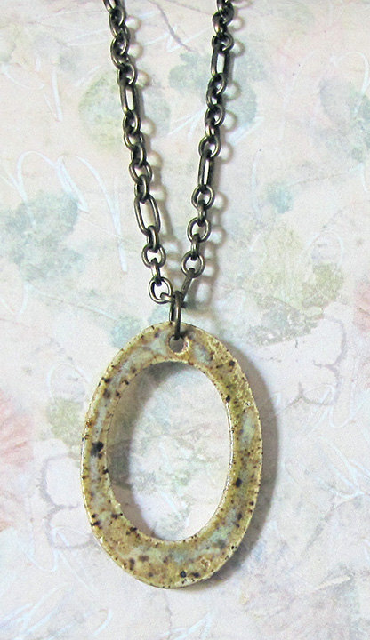 Handmade earth toned oval charm necklace