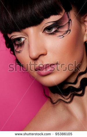 pretty woman with creative makeup and hairstyle on pink background - stock photo