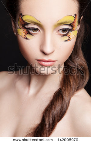 portrait of young woman with creative makeup - stock photo
