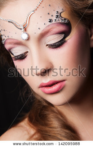 portrait of young woman with creative makeup face art - stock photo