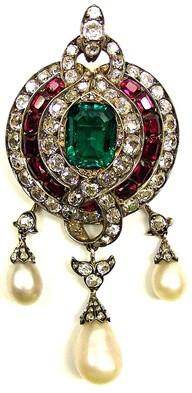 19th century emerald, ruby, diamond and pearl pendant brooch, English c.1860, centred by a trap cut emerald in a triple border of diamonds, rectangular rubies and then diamonds, scroll diamond hoop to…