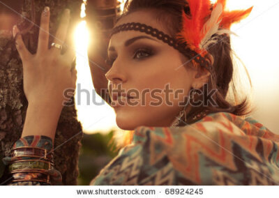 beautiful woman standing near the tree with the sunset on the background - stock photo