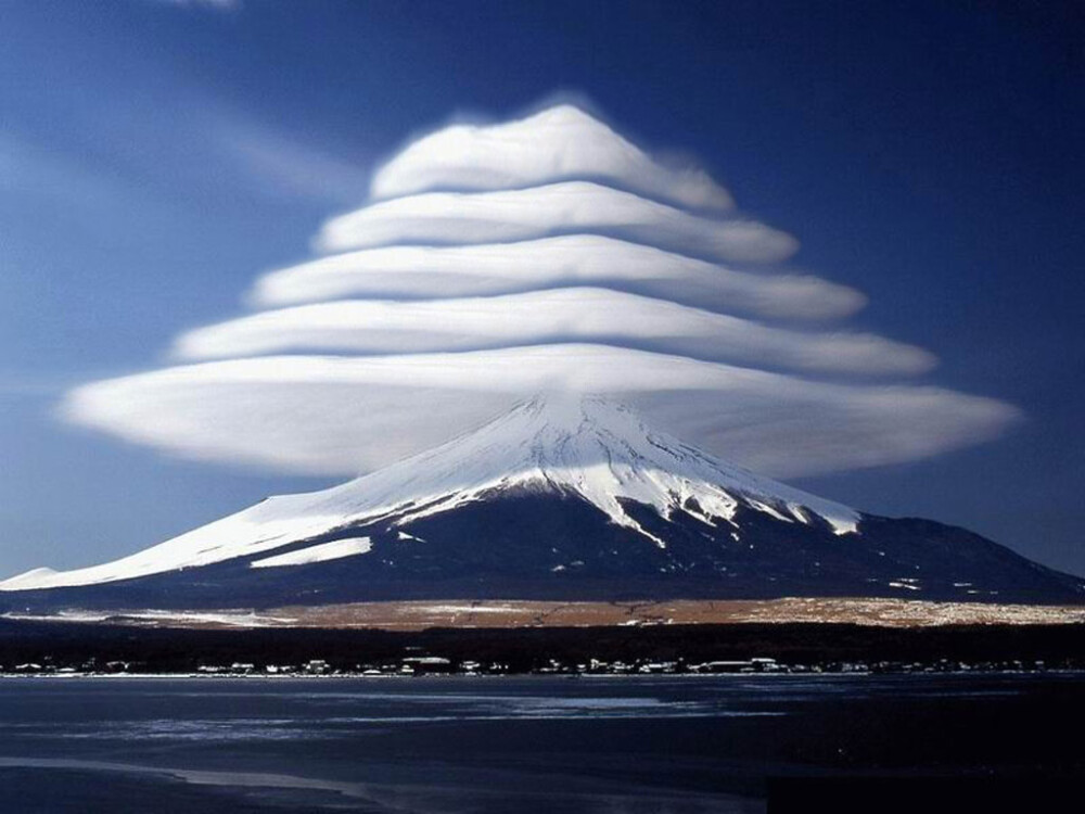 teenage-hoodlum: Lenticular clouds over Mount Fuji, Japan. These are stationary lens-shaped clouds that form at high altitudes, usually perpendicular to the direction of the wind.