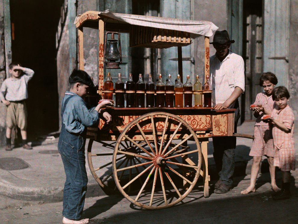 Children gather around a French Quarter snowball wagon in this Autochrome image originally published in the April 1930 issue of National Geographic. "These are the only 'snowballs' the children of New Orleans have ever seen," says the picture's caption, "as snow has not fallen there in fifty years."