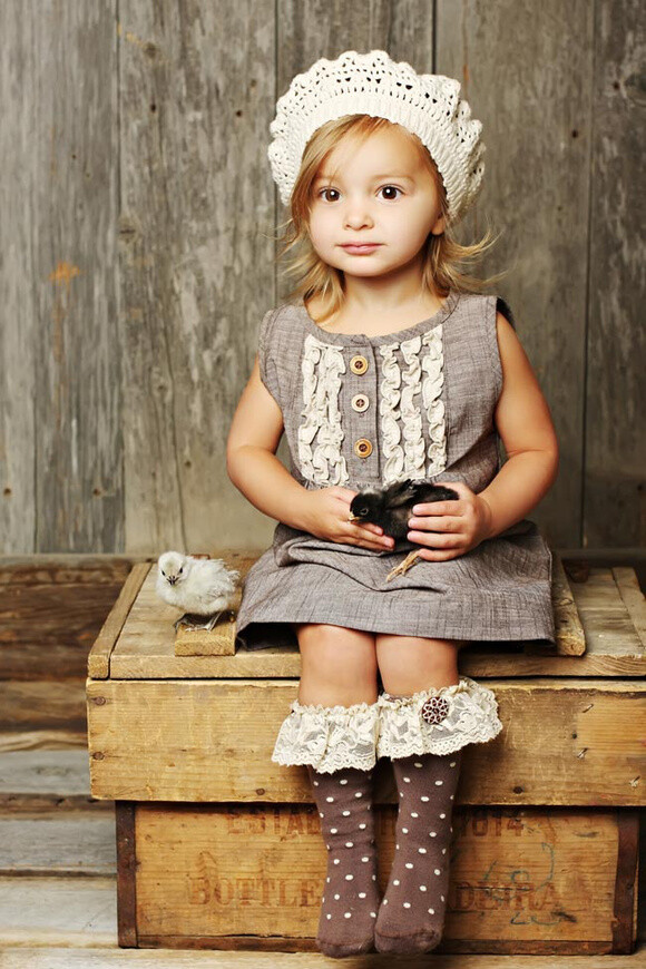 little girl wearing polka dot and lace socks...