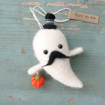 Fuzzy felted ghost with mustache, black hat and orange pumpkin.