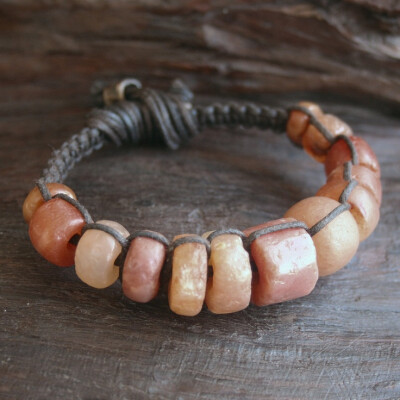 by Ryan Keane | Bracelet; 1000+ Year Old Carnelian Stone Beads that are on Hand Woven Dark Brown Waxed Linen and a Solid Lost Wax Bronze Grips | 65$