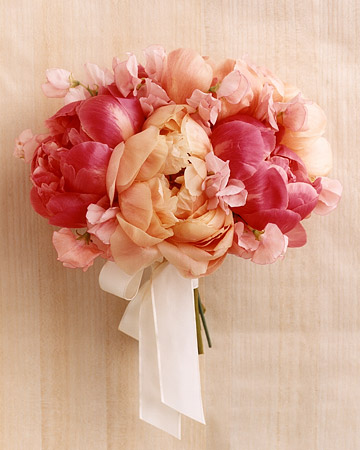 Robin and Matt: New York City The bride's bouquet is composed of giant, lush peonies and ruffly sweet peas in various shades of pink, and is tied with an ivory satin ribbon.