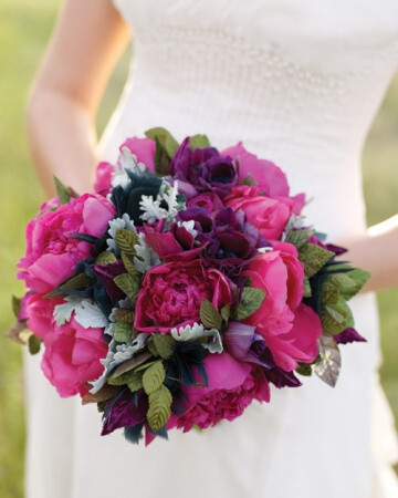 Hot Pink Bouquet Hot-pink peonies, purple anemones, dusty miller, and a few feathers, as well as vintage metallic and fabric leaves, make up this bridal bouquet, by Sharla Flock Designs.