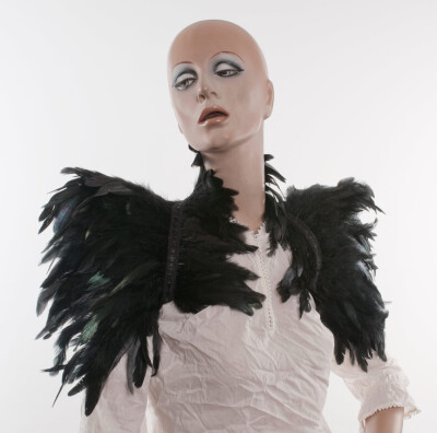 Feather high collar capelet or sharp shoulders wrap shrug dripping with black feathers Versatile feather accessory. $95.00, via Etsy. Burner party love.