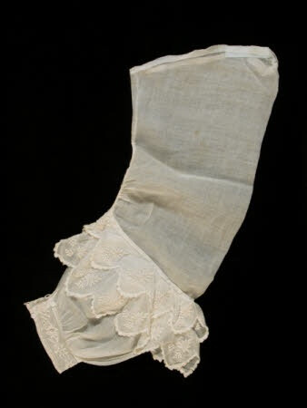 two frills of embroidered muslin above wrist.