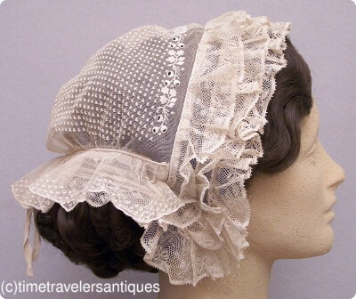 1850s finely hand-embroidered fancy tulle day cap, trimmed in ruffled Mechlin lace. Adjustable twill tape drawstring at the back.