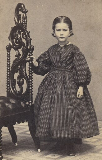 Young girl w/ short hair.