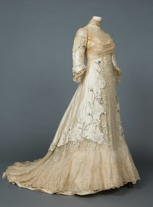 Trained evening gown of ivory silk taffeta and chiffon with lace insertions, chiffon flowers, pin tucks, and silver sequins, c. 1900 (FIDM Museum Collection)