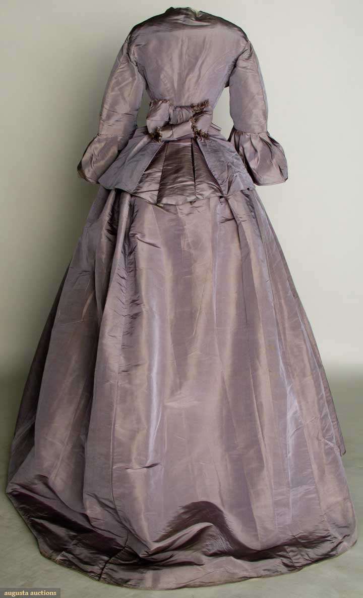 LILAC SILK DAY DRESS, EARLY 1860s 2 piece faille, peplum bodice, trained skirt, B 36", W 21.5", L 41"-57", (light skirt stains, water stains on peplum, alterations, sleeve flounce basted on) very good.