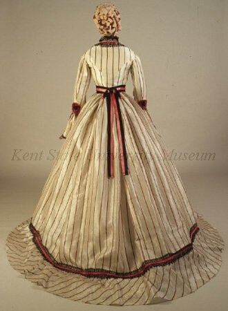 Striped white silk gauze dress (back) with red silk ribbon and black lace trim, and red and black silk sash, American, c. late 1860s.