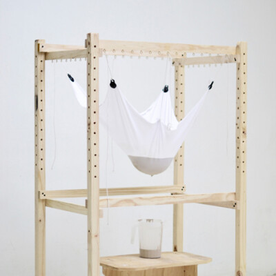 The Catenary Pottery Printer by gt2P comprises a wooden frame from which sheets of gauze, muslin or lycra can be suspended and used to slip-cast ceramics.
