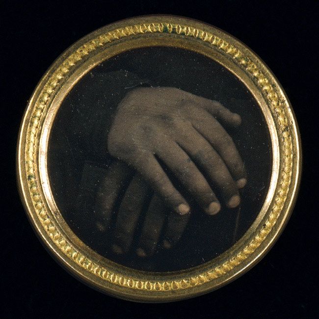 Daguerreotype button with an abolitionist motif may be one of the first political buttons made in America to incorporate a photograph. Believed to be unique, the miniature daguerreotype shows two hands held together, one black, one white, resting on a book assumed to be the Bible. The photograph is