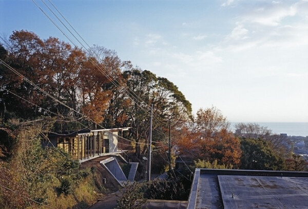 This cool house located on the sunny hillside of Hakone's mountain range was designed by Japanese architecture studio Mount Fuji. This small modest house with a breathtaking view on the city and bay, is hidden among the trees, which protect it from strong winds. Stunningly simple wooden interior is