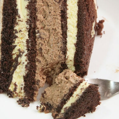 A Rich and fluffy four layer chocolate cake with chocolate mousse and white chocolate frosting.. Chocolate Layered Mousse Dessert Recipe from Grandmothers Kitchen.