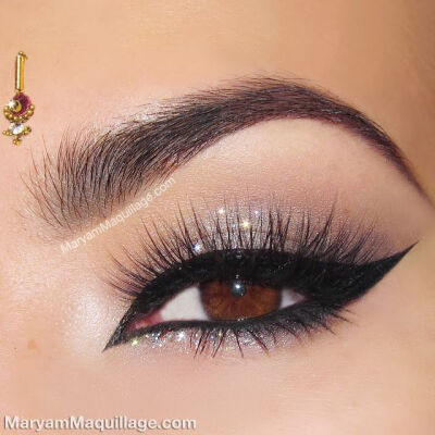 Heavily lined and winged, beautiful glitter eye makeup