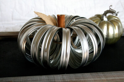 How clever! It's a pumpkin made from mason jar lids, by hawthornehill on Etsy.