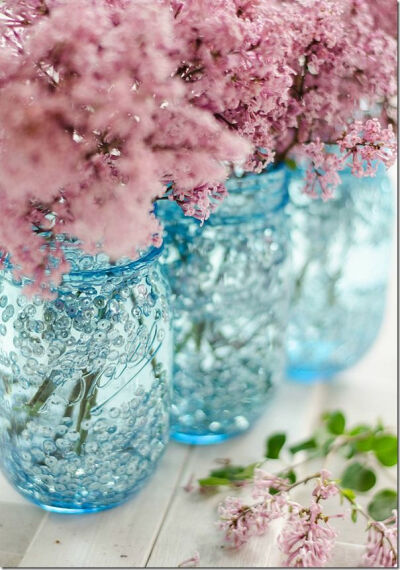 Blue and sequin Ball mason jar vase DIY - 100th anniversary edition blue jars. Looks like little bubbles floating around. Bet this would look great with a candle in it too!