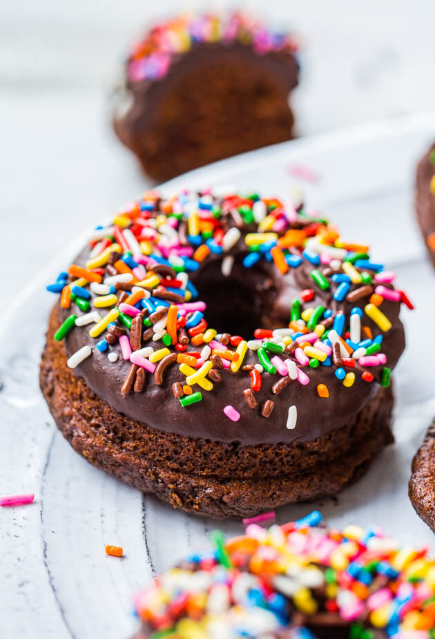 Baked Chocolate Donuts with Chocolate Ganache and Sprinkles - Making donuts at home is as easy as making muffins! They're baked rather than fried so you can have seconds, of course!