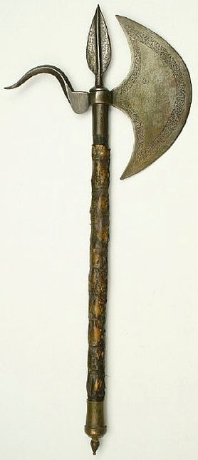 Sudanese Battleaxe, 19th century, broad crescent blade comes with a flared back spike while the wooden shaft is covered in crocodile skin and surmounted with a short leaf-shaped spear tip. The head is etched with Arabic inscriptions, 55 cm overall length.