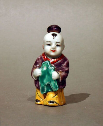 Figural Snuff Bottle in the Form of a Boy with Cash