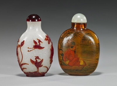 Two various Chinese glass snuff bottles: amber color with inside painted designs of boys playing in a garden, verso with a scholar and attendant in a boat, early 20th Century; and a carved ruby red ov…