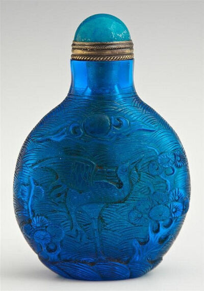 Chinese Cobalt Blue Peking Glass Snuff Bottle, c. 1900, of flattened rounded form, carved with a carp on one side and a stork on the other, with a blue Peking glass stopper, from the Christian collect…