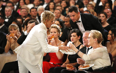 Ellen DeGeneres hands out pizza she ordered from backstage.