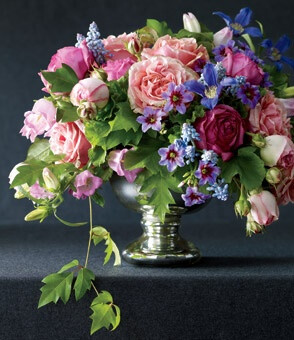 Trailing grape ivy frames this sweet mélange of Finesse, Pierre de Ronsard, and Dorben roses combined with clematis, campanula, muscari, geraniums, and leucocoryne. “Classic” floral design by Lewis Miller, LMD Floral Events Interiors, NYC.