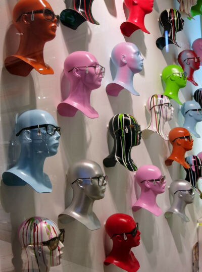 Golden Eyes Opticians uses repetition of heads in so many different colours.