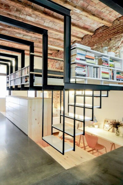 Love that the renovation of this building (turning it from a dry cleaning shop into a home) involved stripping it down to the original wooden ceiling beams and stone/brick walls