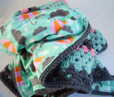 Crocheted blanket with umbrella fabric lining. I like the idea of lined crochet blankets