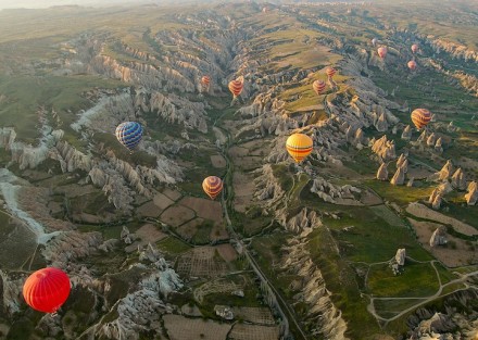 卡帕多西亚（Cappadocia），位于土耳其中部的卡帕多西亚以其童话般的斑点岩层而闻名：奇特的岩石构造、岩洞和半隐居人群的历史遗迹令人神往。很多地方都可以乘坐热气球,但卡帕多西亚一定是最奇特的。每天，随着太阳的升起，数以百计的热气球开始带着游客们光顾这片土地，形成这些壮观的景象...