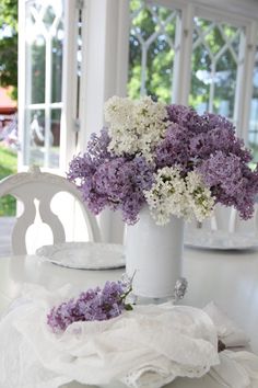 Arrangement of lilacs in a white glass vase Spring Flower Arranging Ideas