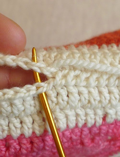 To whip stitch, I brought the needle under both strands of the edge stitches. Instead of turning the needle around to come back the other way, I pushed my needle through in the same direction for every stitch.