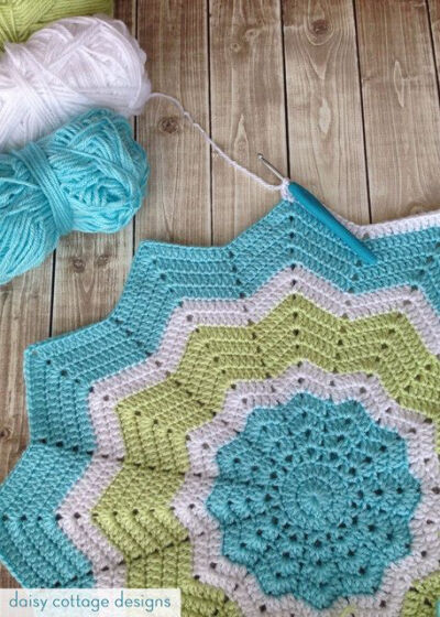 12 Point Star Crochet Baby blanket in turquoise, lime, and white.