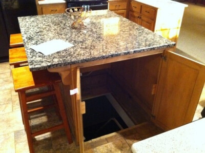 In a crazy way, I kinda love this. For an underground storm shelter/panic room/secret hideout in the kitchen island! Best secret passage ever!!