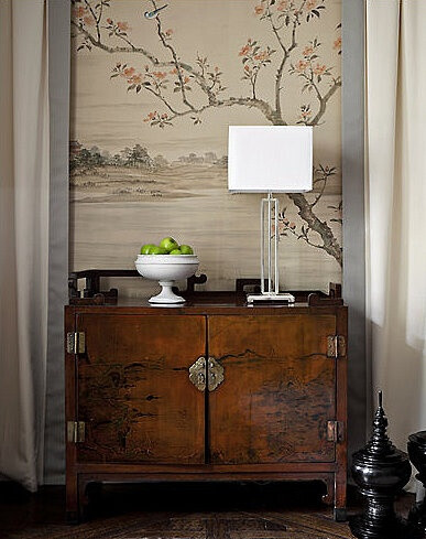 Chinese cabinet with panel of wallpaper behind - want to do this in bedroom
