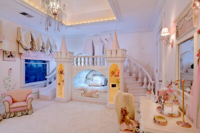 This bed (complete with balcony and slide) by Sweet Dream Bed Children's Interiors has drawers that pull out from the stairs and a rock climbing wall!
