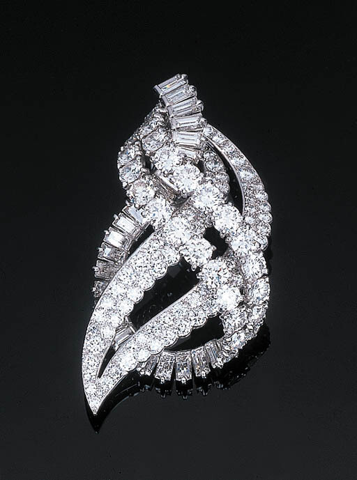 A Diamond Pendant Brooch by Cartier Of scrolled openwork design, set with four circular-cut diamond rows with a further scrolled baguette-cut diamond line, hidden pendant hook, with French assay and maker's marks, in a fitted red leather case, 5.5 cm lo