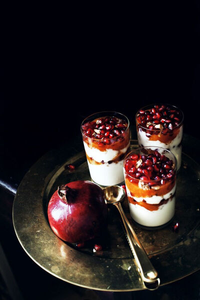 Seasonal yogurt parfait with persimmon, pomegranate and granola.