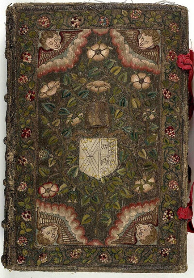 17th century embroidered Canvas book, pictorial angel and floral motif with two red ribbons. Embroidered Canvas book, pictorial angel and floral motif with two red ribbons. The Booke of Common Prayer …