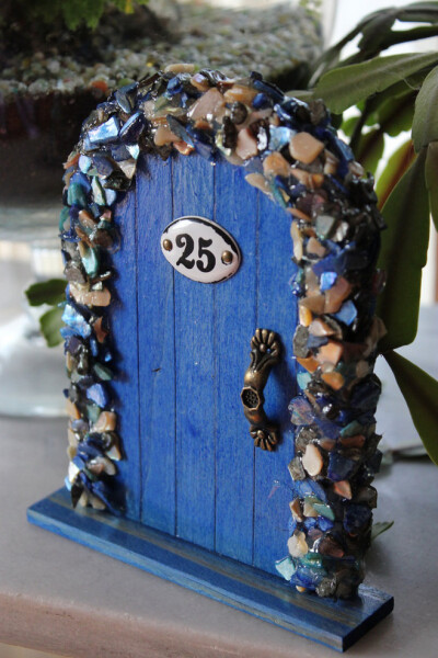 Miniature Wood Fairy Hobbit Door Blue Shells. $15.00, via Etsy.