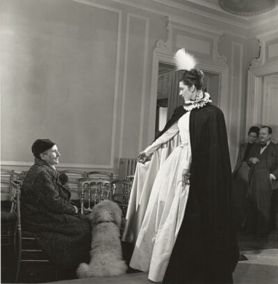 Gertrude Stein and model in Pierre Balmain’s salon, with Rosamond Bernier in the background. Photograph by Horst P. Horst