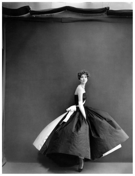 Suzy Parker is wearing a black taffeta with very wide skirt and white taffeta panel in back, white taffeta sash, white taffeta petticoat by Grès, photo by Richard Avedon, Paris Studio, August 1956